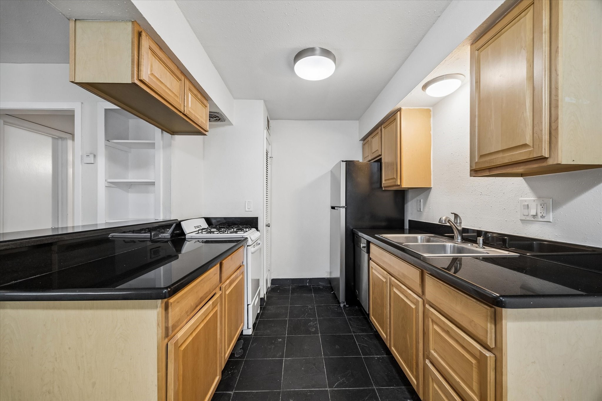 2206 Mason Street, Unit 7 Houston, TX 77006 - Photo 6 of 11 a kitchen with granite countertop a sink and cabinets