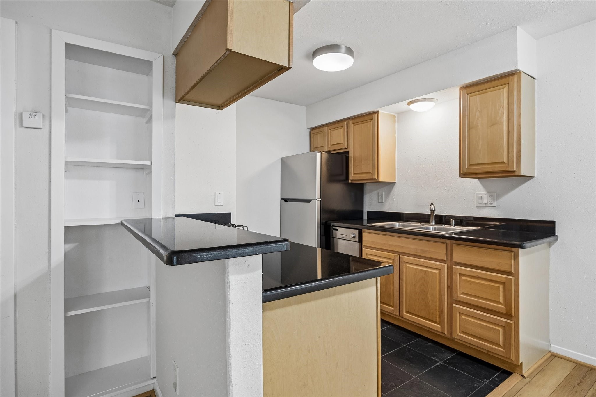 2206 Mason Street, Unit 7 Houston, TX 77006 - Photo 8 of 11 a kitchen with stainless steel appliances granite countertop a refrigerator and a sink