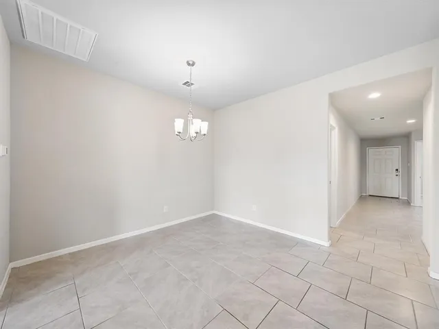 an empty room with a empty space and windows