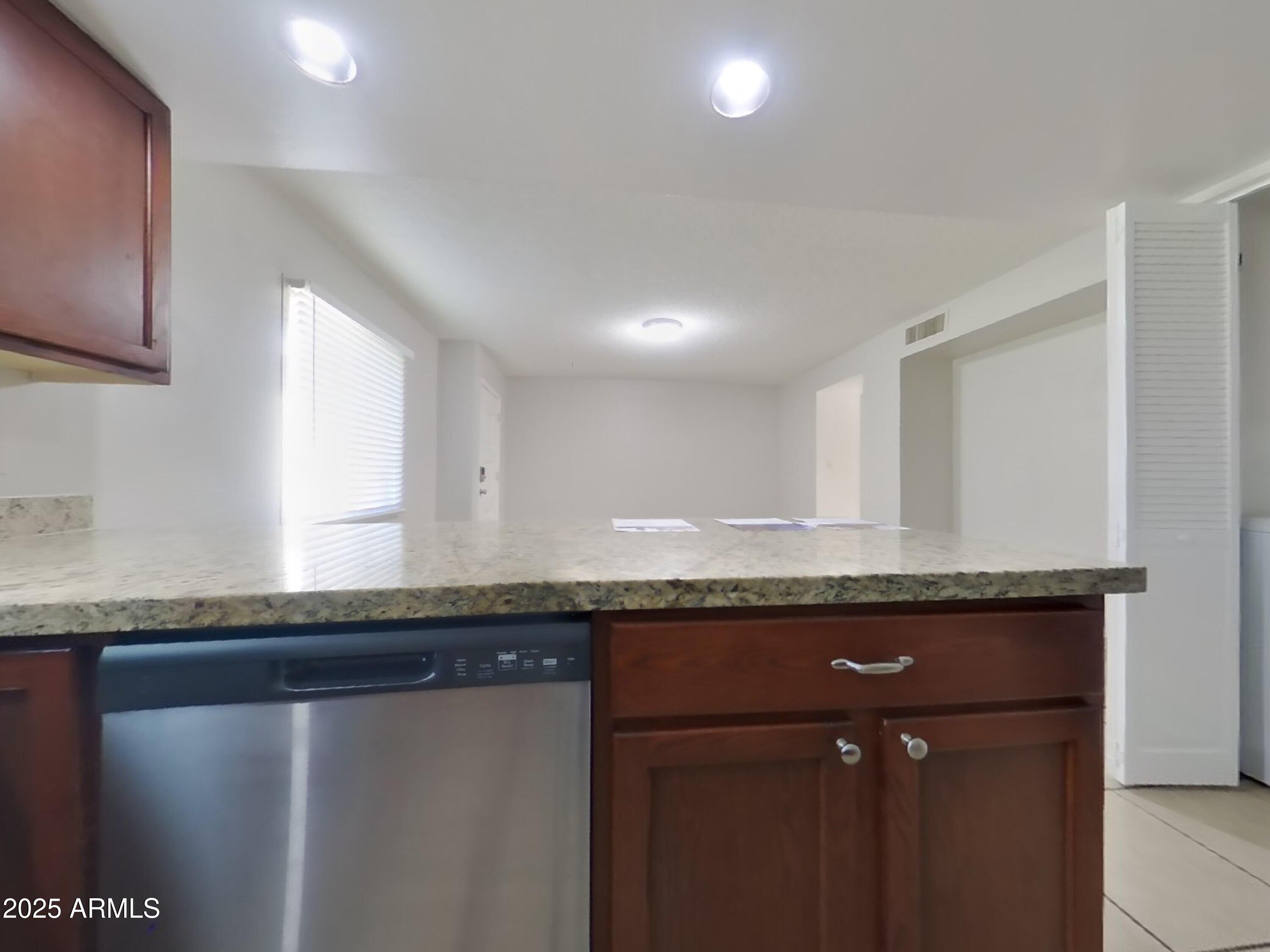5025 South Mill Avenue Tempe, AZ 85282 - Photo 15 of 18 a kitchen with granite countertop stainless steel appliances and a counter space