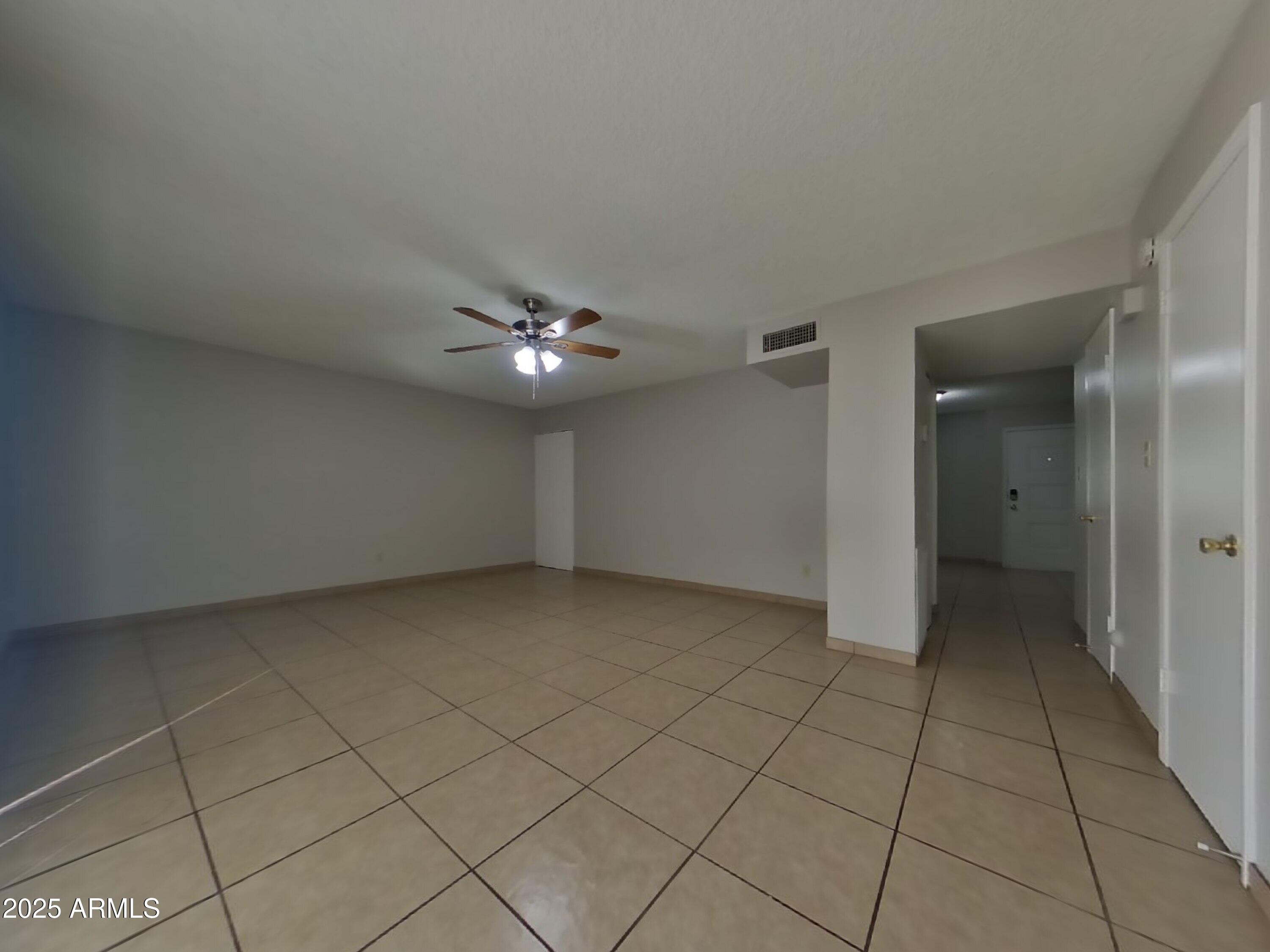 5025 South Mill Avenue Tempe, AZ 85282 - Photo 9 of 18 an empty room with fan and entrance