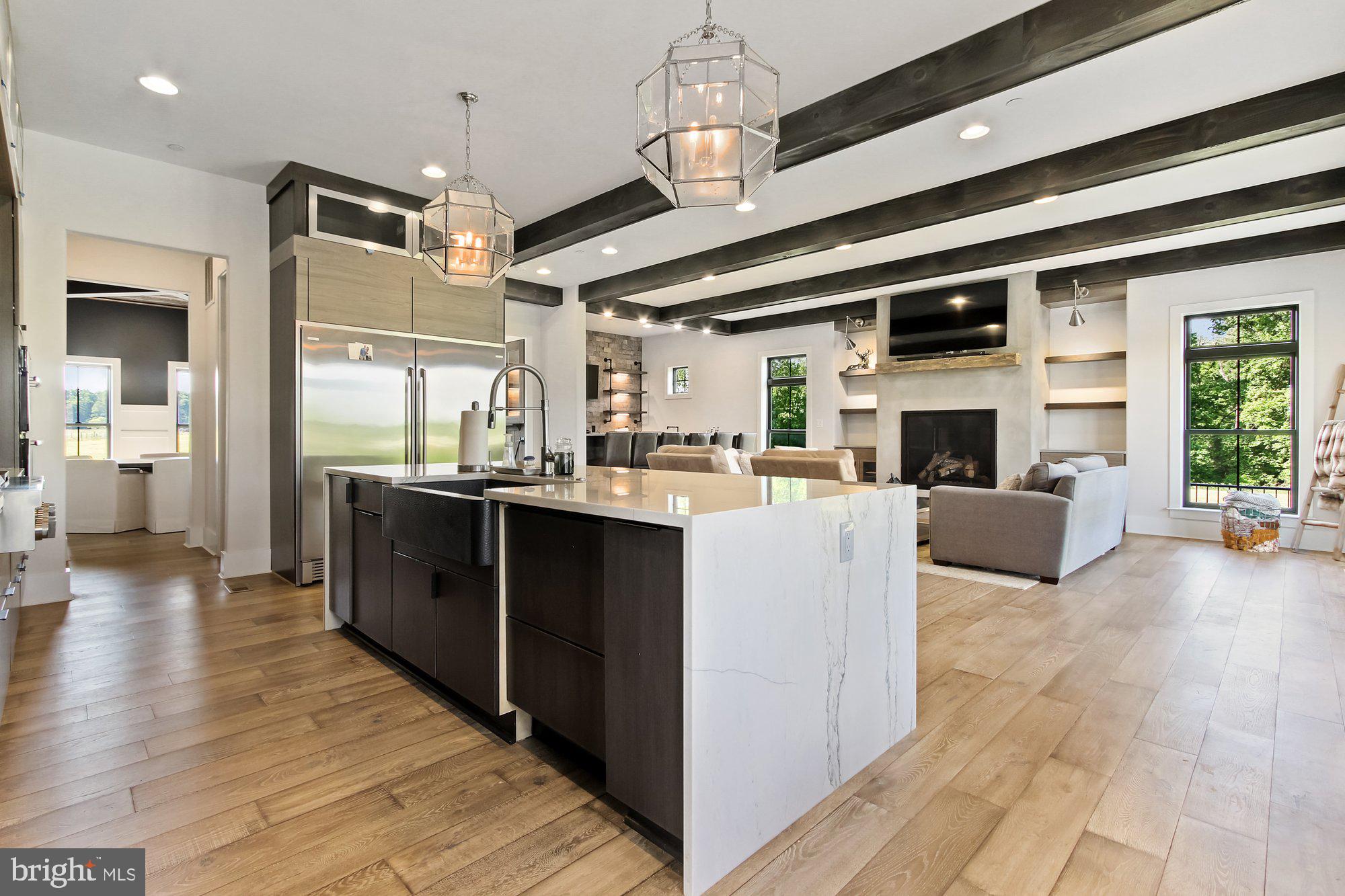 2033 Connolly Road Fallston, MD 21047 - Photo 13 of 49 a kitchen with stainless steel appliances granite countertop a refrigerator a sink dishwasher and a dining table with wooden floor