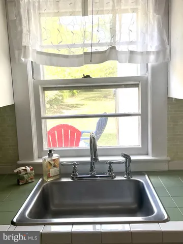 a view of a dining room with furniture and chandelier fan