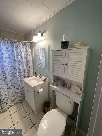 a bed sitting in a bedroom next to a window with a wooden floor