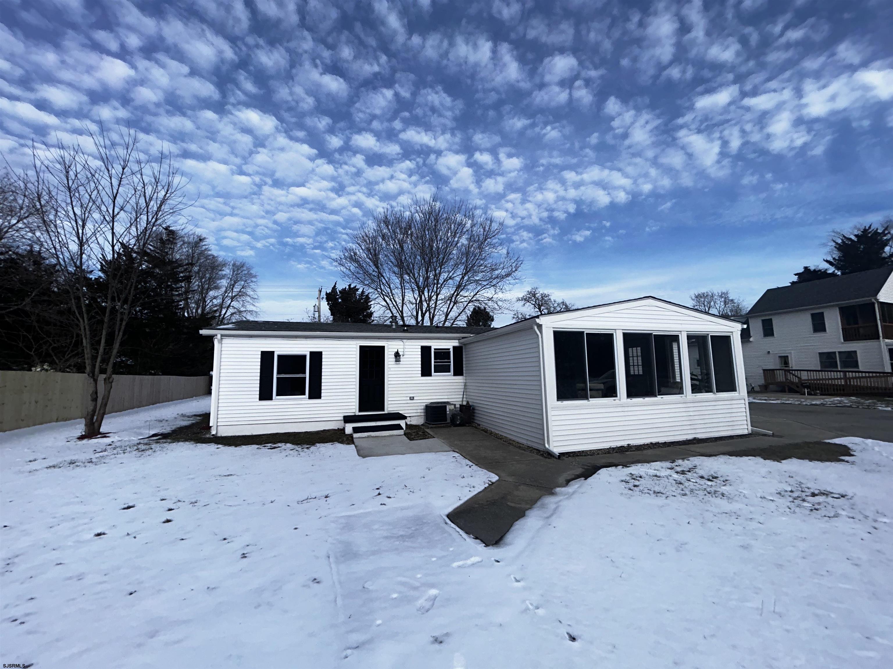 48 Leeds Point Road Galloway Township, NJ 08205 - Photo 4 of 33 a front view of a house with yard covered in snow