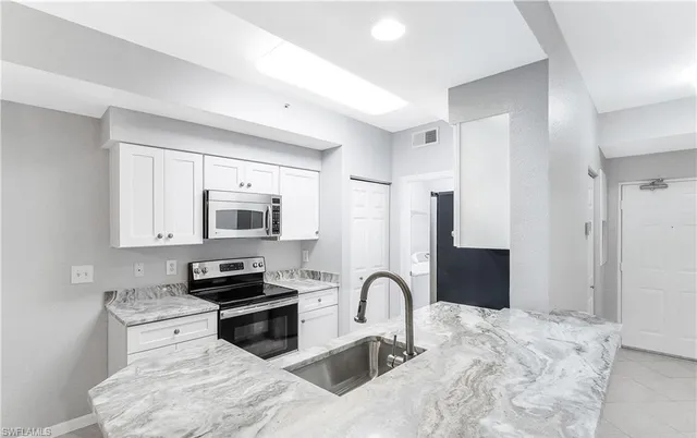 a bathroom with a sink mirror vanity and toilet