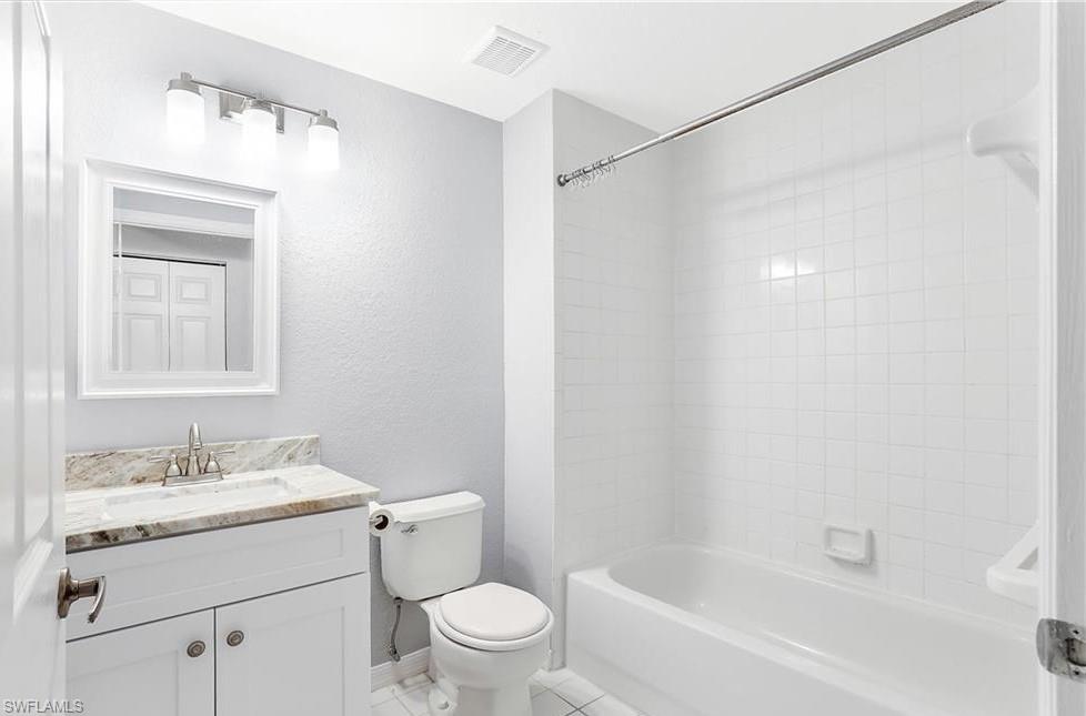 4635 St Croix Lane, Unit 1215 Naples, FL 34109 - Photo 13 of 22 a bathroom with a sink mirror vanity and toilet