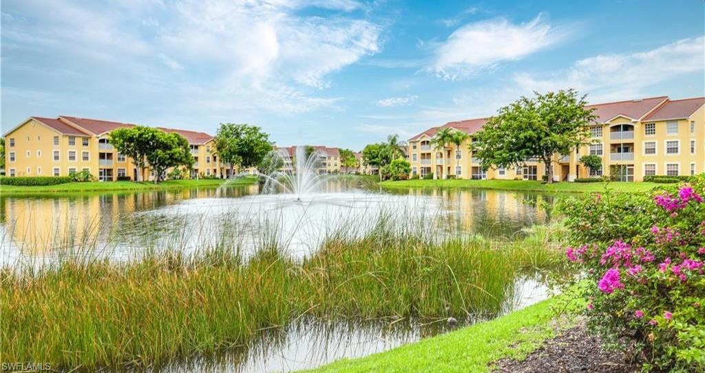 4635 St Croix Lane, Unit 1215 Naples, FL 34109 - Photo 19 of 22 a view of a lake with a big yard