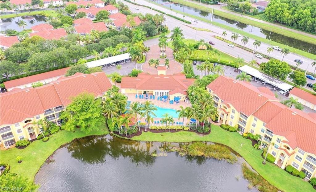 4635 St Croix Lane, Unit 1215 Naples, FL 34109 - Photo 4 of 22 a view of swimming pool with a yard and plants