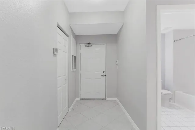 a view of a kitchen with a sink and a refrigerator