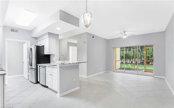 a kitchen with stainless steel appliances a stove microwave and sink