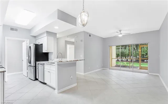 a kitchen with stainless steel appliances a stove microwave and sink
