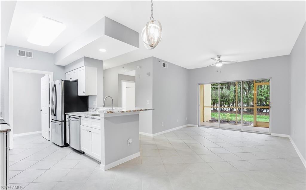 4635 St Croix Lane, Unit 1215 Naples, FL 34109 - Photo 8 of 22 a open kitchen with cabinets stove and refrigerator