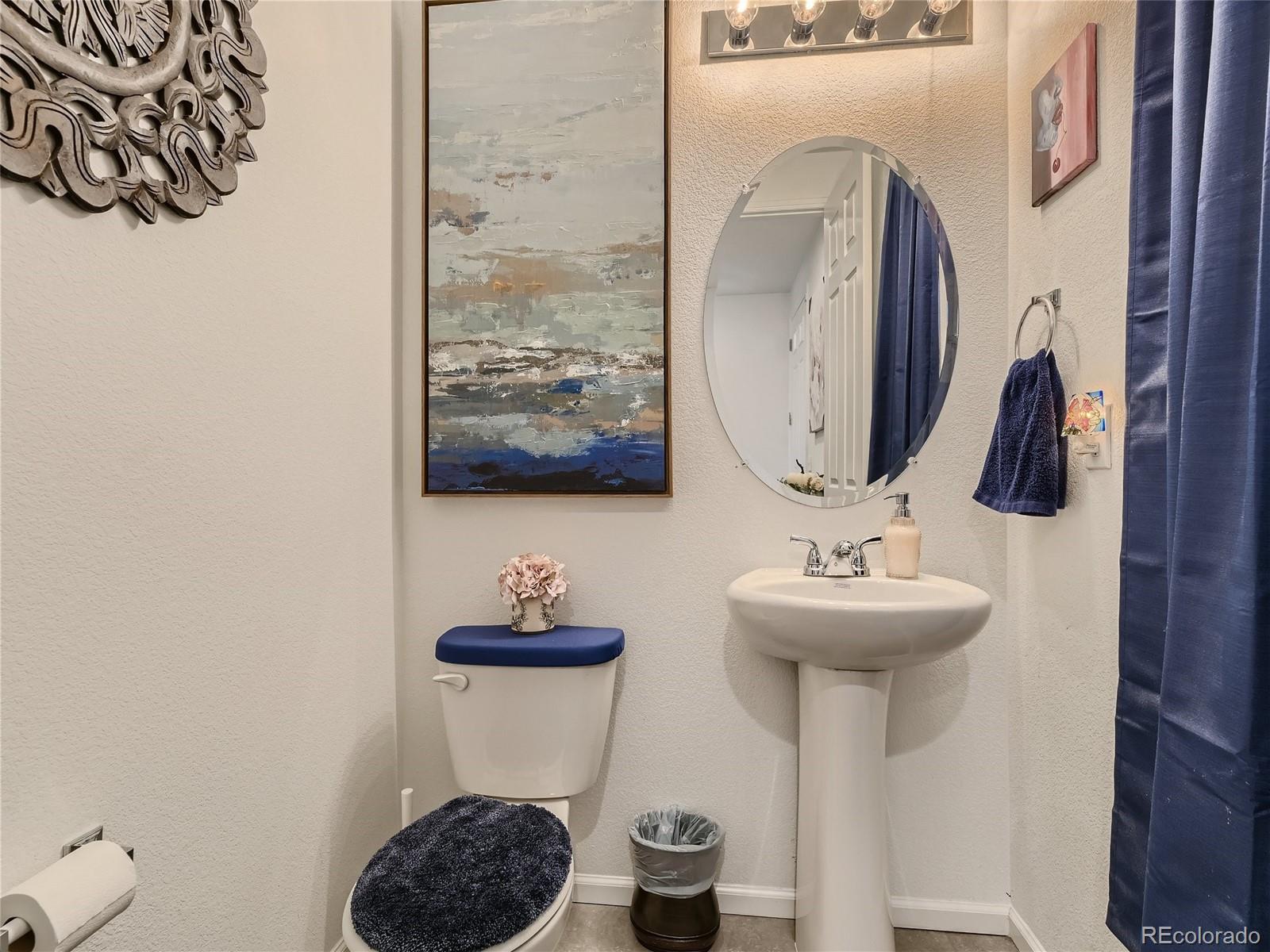 219 South Kellerman Street Aurora, CO 80018 - Photo 13 of 28 a bathroom with a toilet sink and mirror