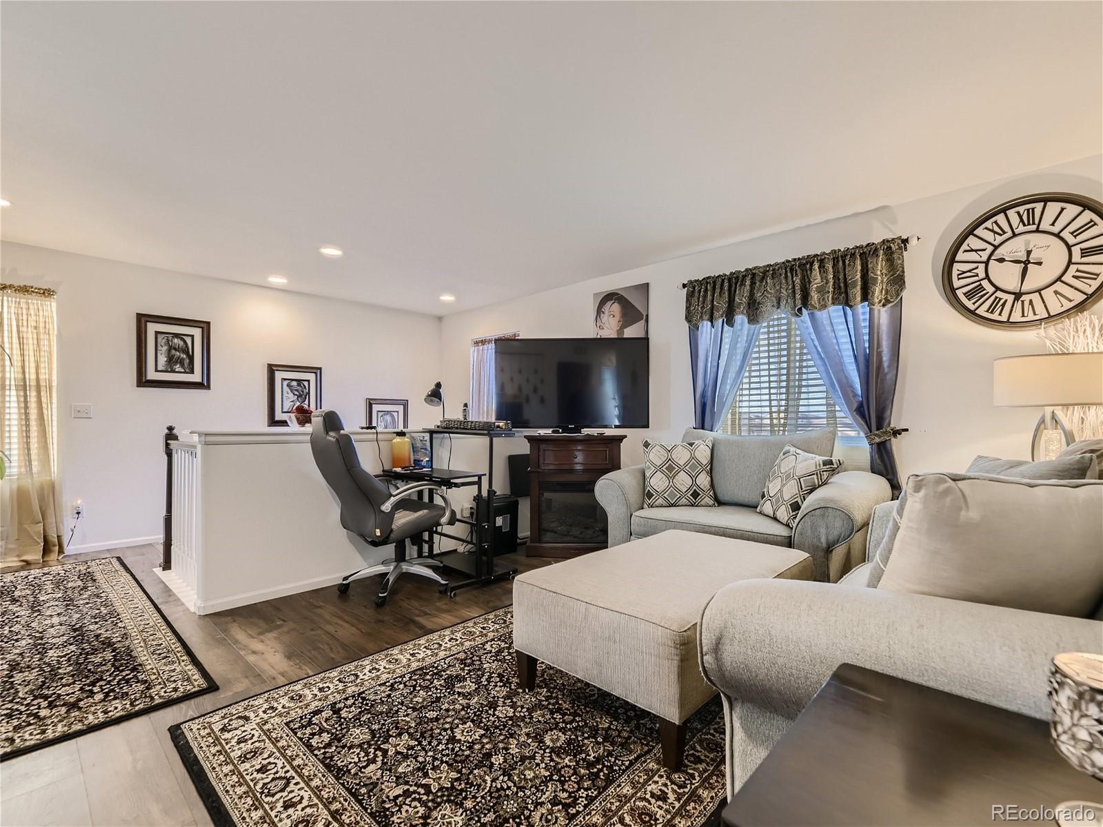 219 South Kellerman Street Aurora, CO 80018 - Photo 14 of 28 a living room with furniture and a flat screen tv