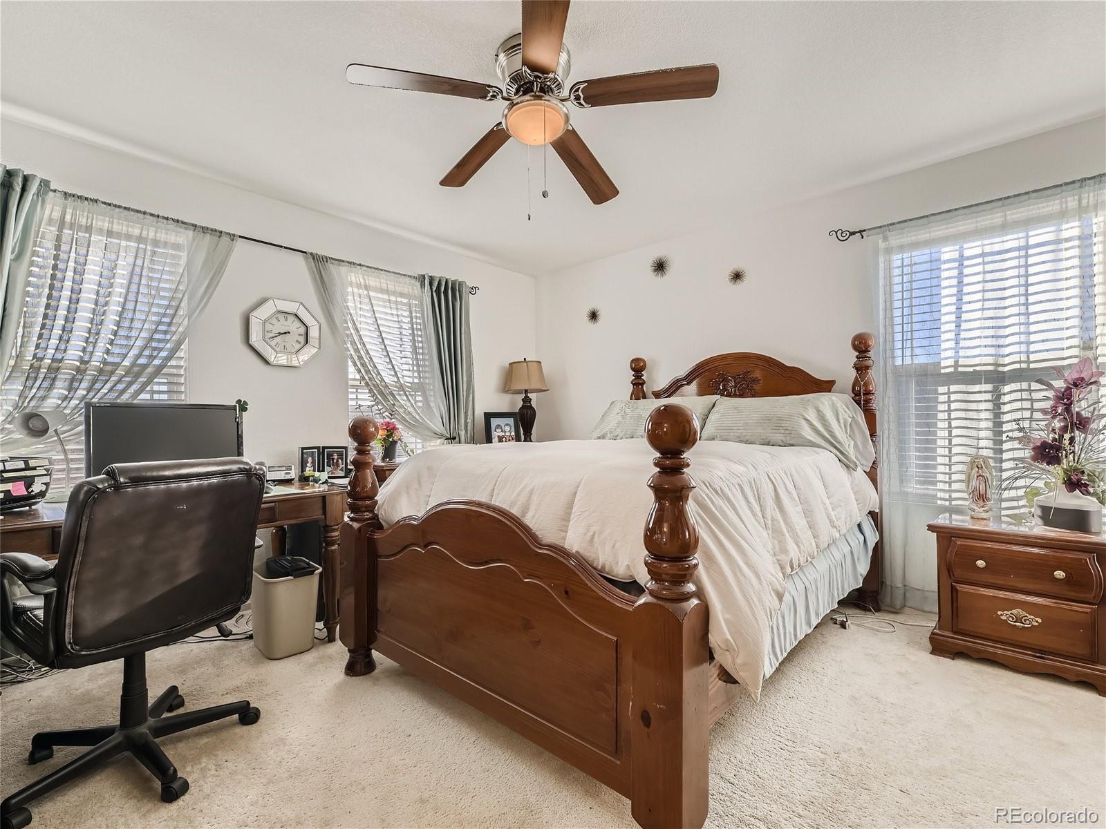 219 South Kellerman Street Aurora, CO 80018 - Photo 17 of 28 a bedroom with a bed and a chandelier