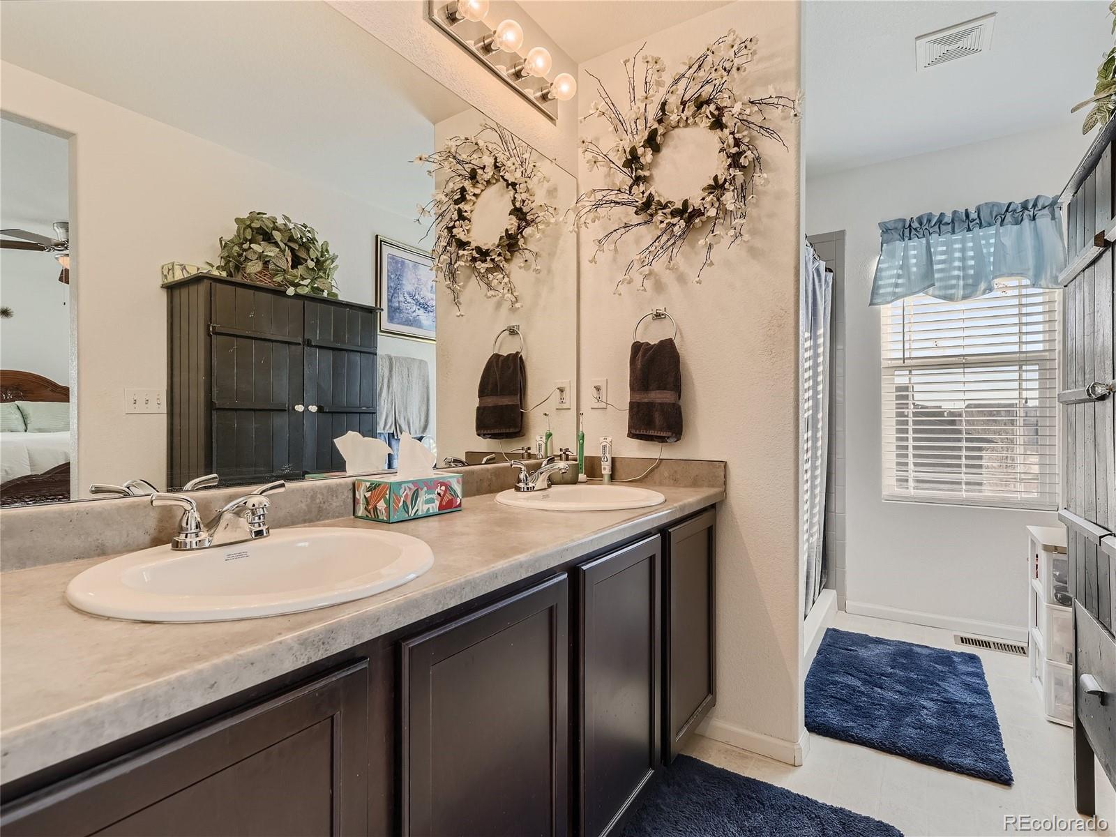 219 South Kellerman Street Aurora, CO 80018 - Photo 19 of 28 a bathroom with a sink double vanity and a mirror