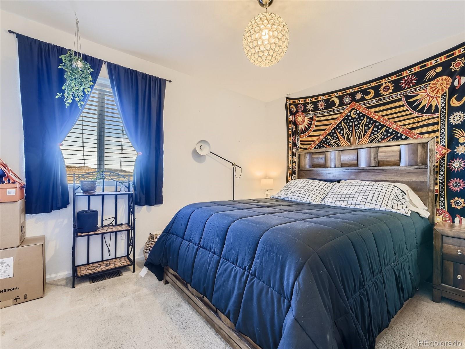 219 South Kellerman Street Aurora, CO 80018 - Photo 20 of 28 a bedroom with a bed and a window