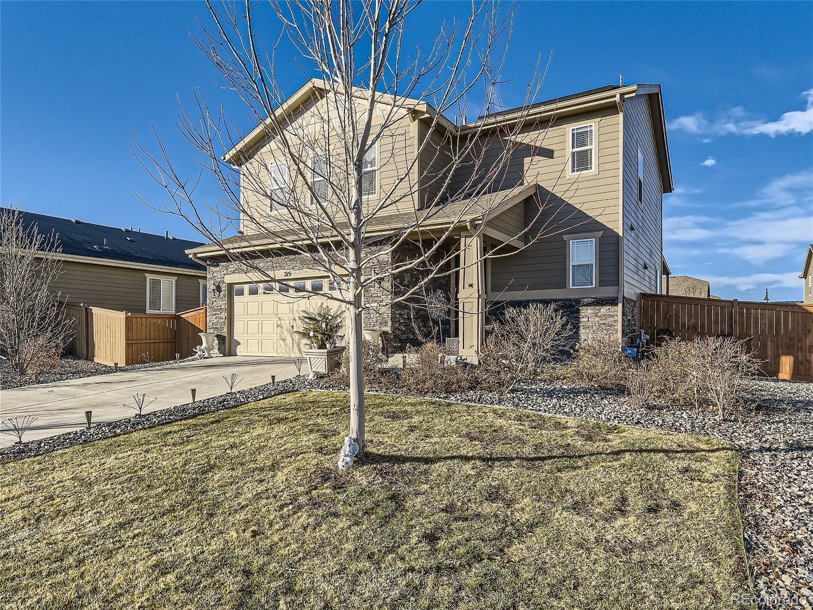 219 South Kellerman Street Aurora, CO 80018 - Photo 3 of 28 a house with trees in the background