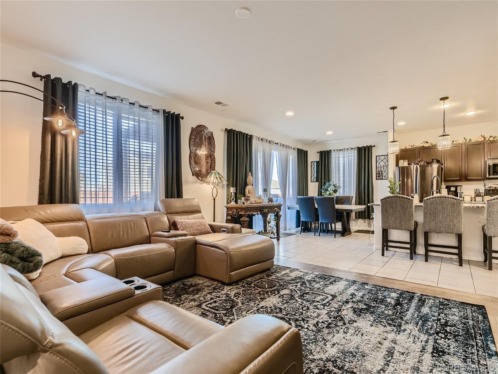 219 South Kellerman Street Aurora, CO 80018 - Photo 6 of 28 a living room with furniture and a large window