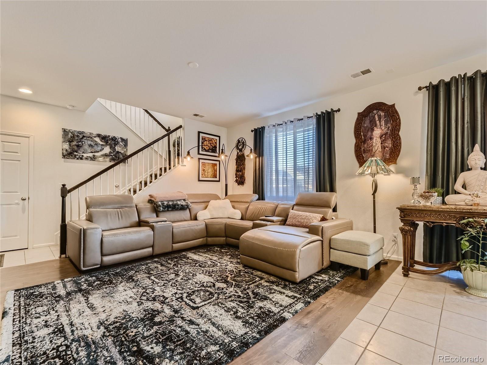219 South Kellerman Street Aurora, CO 80018 - Photo 7 of 28 a living room with furniture and a fireplace