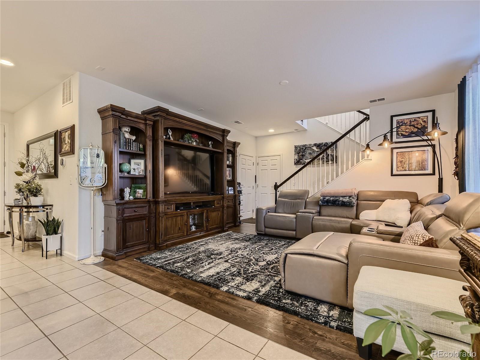 219 South Kellerman Street Aurora, CO 80018 - Photo 8 of 28 a living room with furniture and a flat screen tv