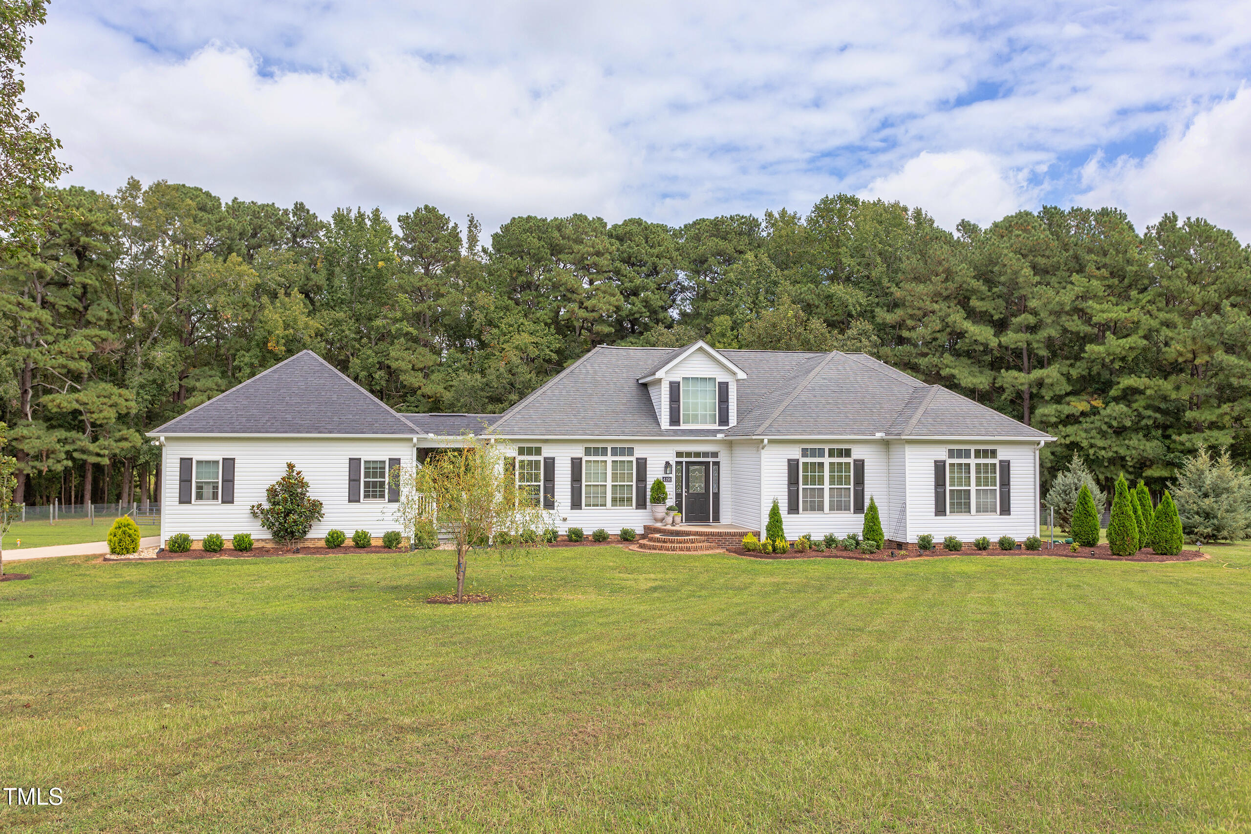 4191 Bobbitt Road Kittrell, NC 27544 - Photo 81 of 89 a front view of a house with a garden and trees