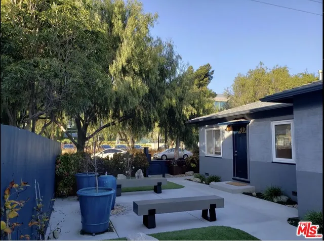 a backyard of a house with yard and outdoor seating