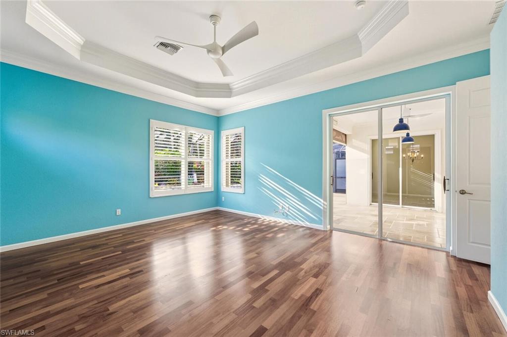 7838 Founders Circle Naples, FL 34104 - Photo 20 of 31 a view of an empty room with wooden floor and a window