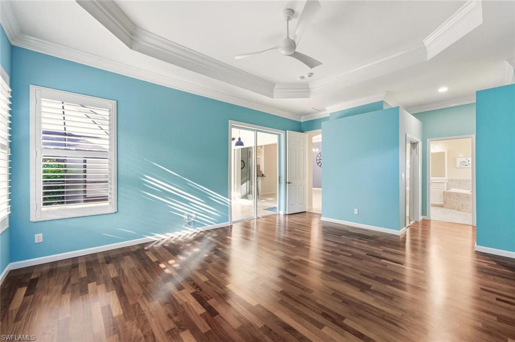 7838 Founders Circle Naples, FL 34104 - Photo 21 of 31 a view of an empty room with wooden floor and a window
