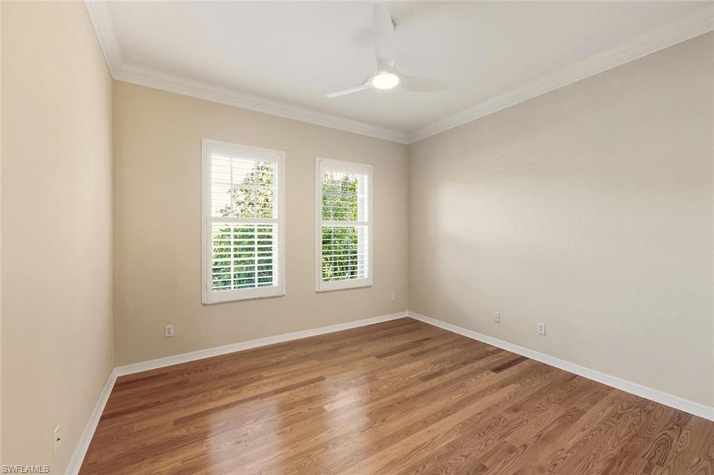 7838 Founders Circle Naples, FL 34104 - Photo 23 of 31 an empty room with wooden floor and windows
