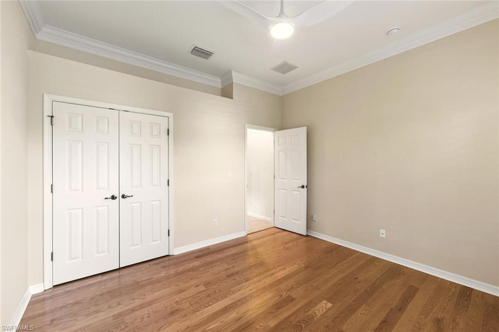 7838 Founders Circle Naples, FL 34104 - Photo 24 of 31 a view of an empty room with wooden floor