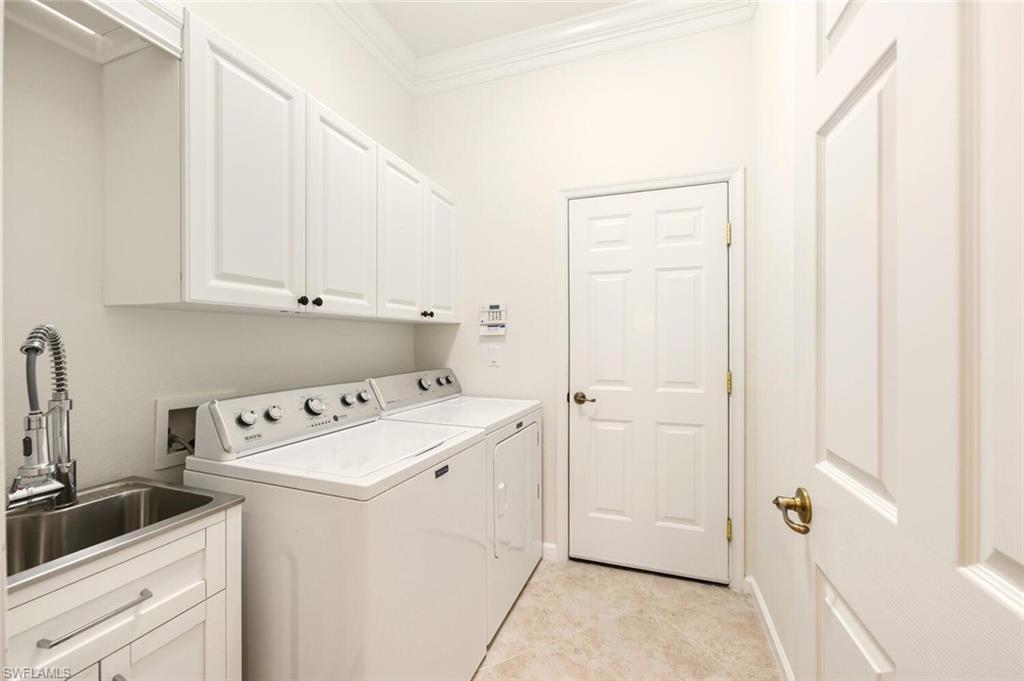 7838 Founders Circle Naples, FL 34104 - Photo 27 of 31 a utility room with dryer and washer