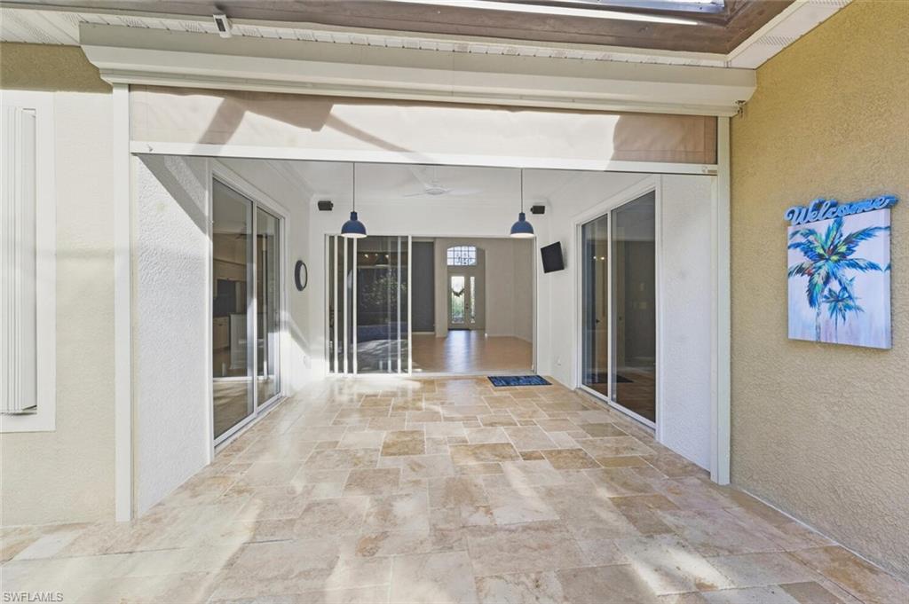 7838 Founders Circle Naples, FL 34104 - Photo 31 of 31 a view of an entryway with a chandelier