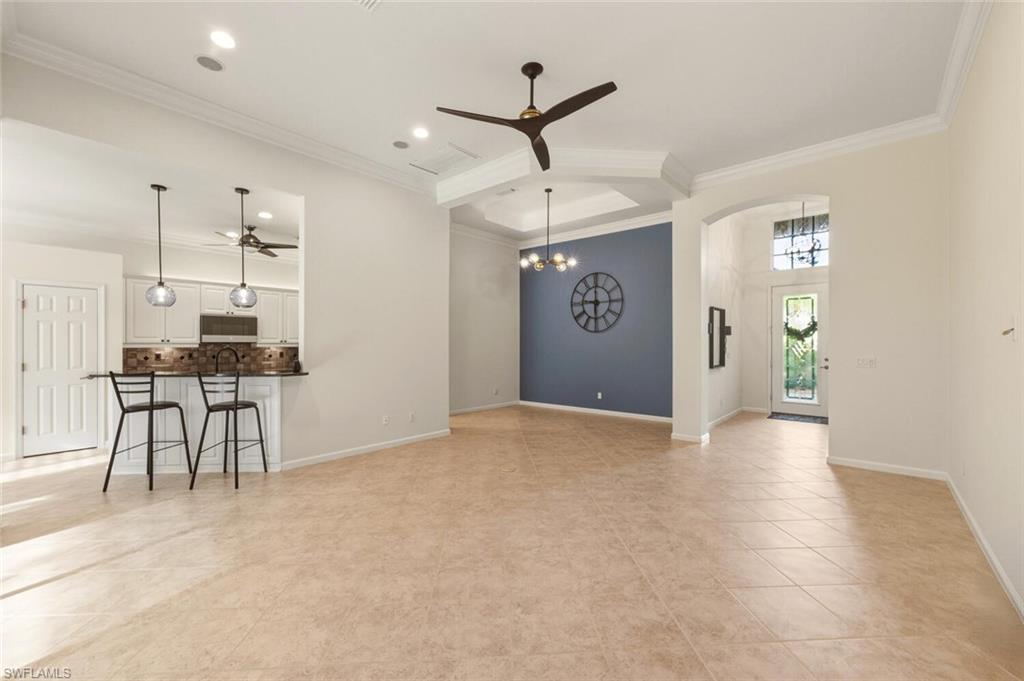 7838 Founders Circle Naples, FL 34104 - Photo 7 of 31 a view of an empty room with kitchen and a window