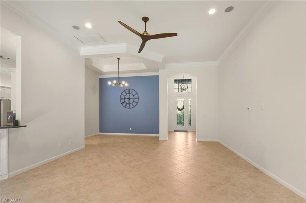 7838 Founders Circle Naples, FL 34104 - Photo 8 of 31 an empty room with a ceiling fan and window