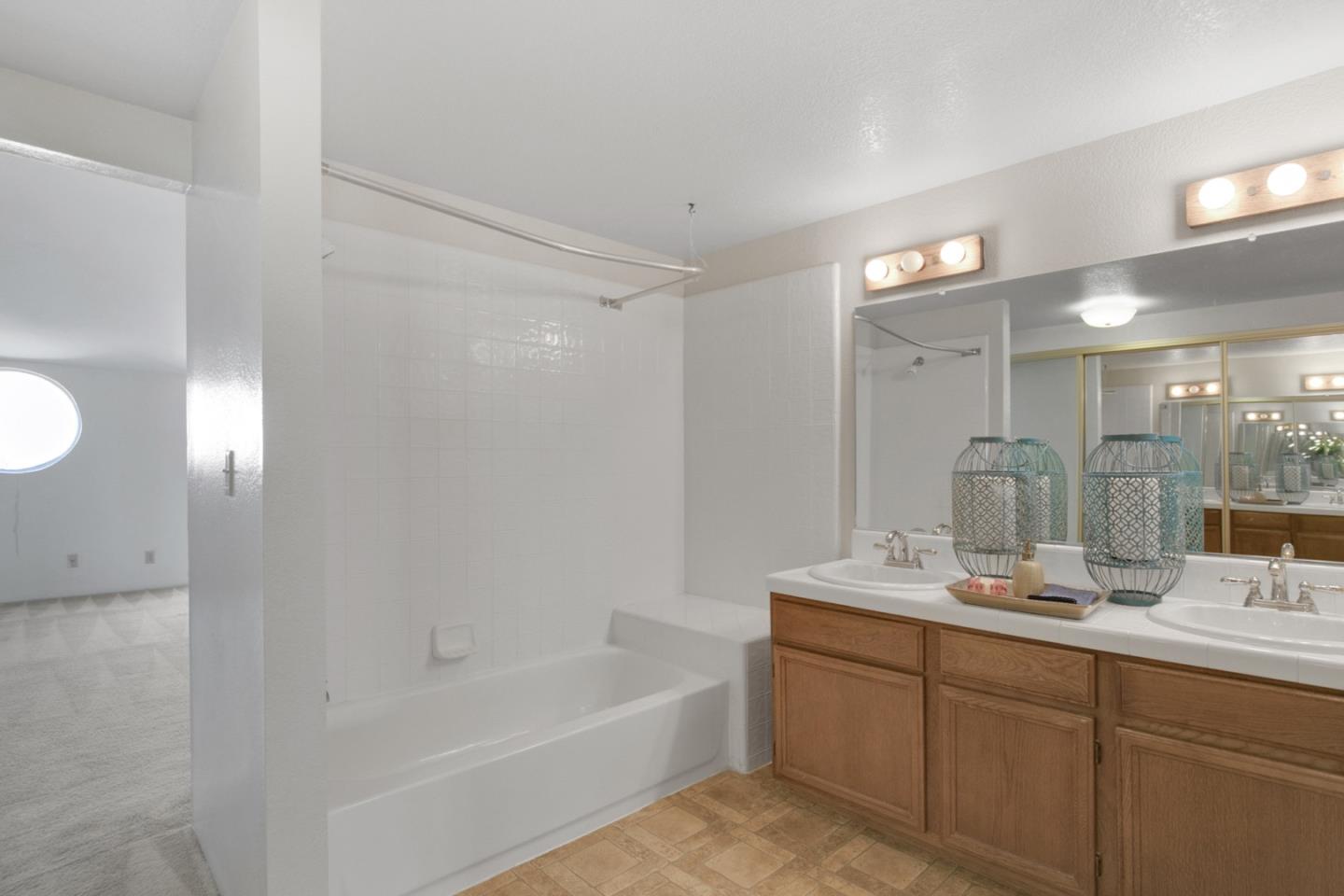 20 Seacliff Drive Aptos, CA 95003 - Photo 19 of 38 a bathroom with a tub sink double vanity and mirror
