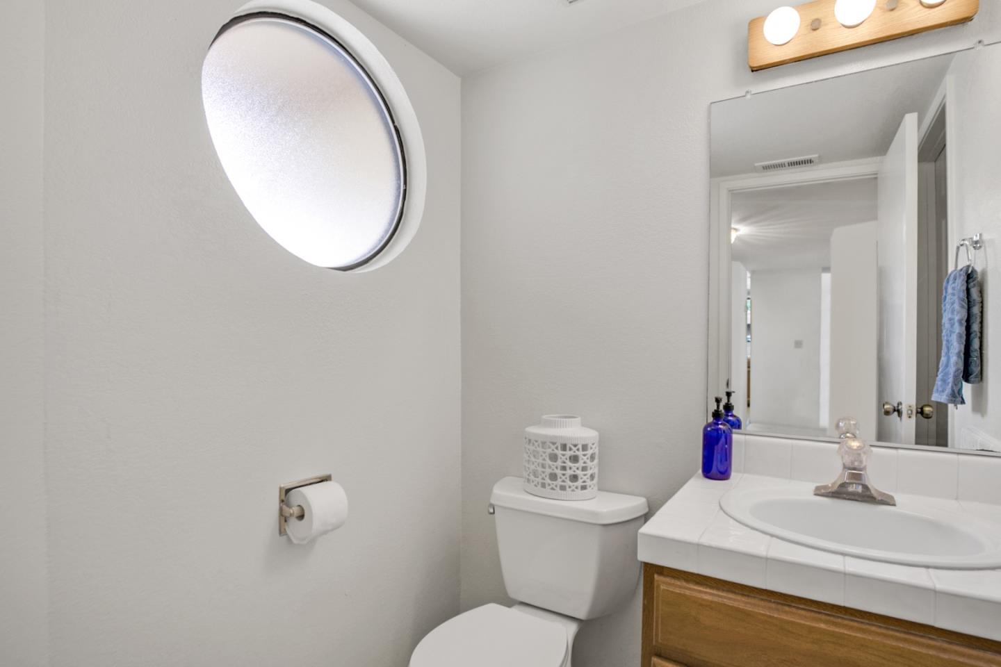 20 Seacliff Drive Aptos, CA 95003 - Photo 30 of 38 a bathroom with a sink and a mirror