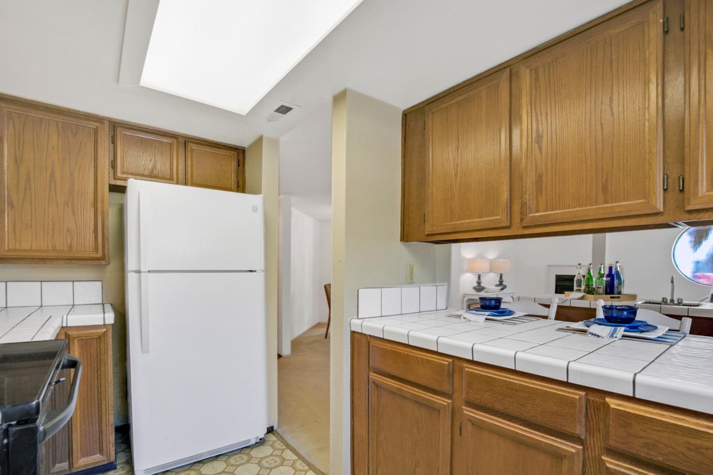 20 Seacliff Drive Aptos, CA 95003 - Photo 10 of 38 a kitchen with stainless steel appliances granite countertop a refrigerator a sink a stove and white cabinets
