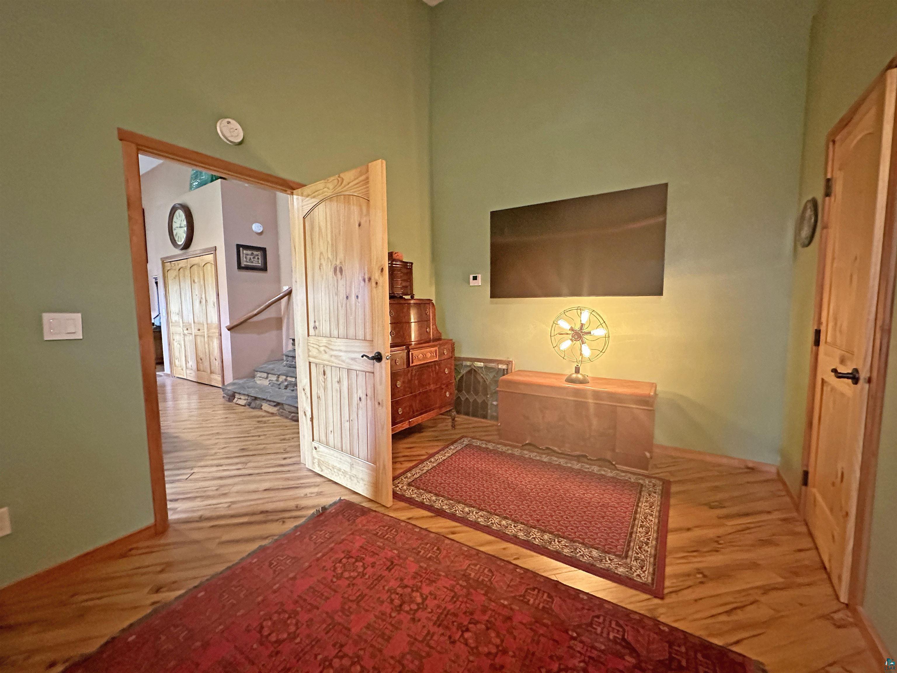 5865 Eastview Road Iron River, WI 54847 - Photo 14 of 41 Hall with a towering ceiling and light wood-type flooring