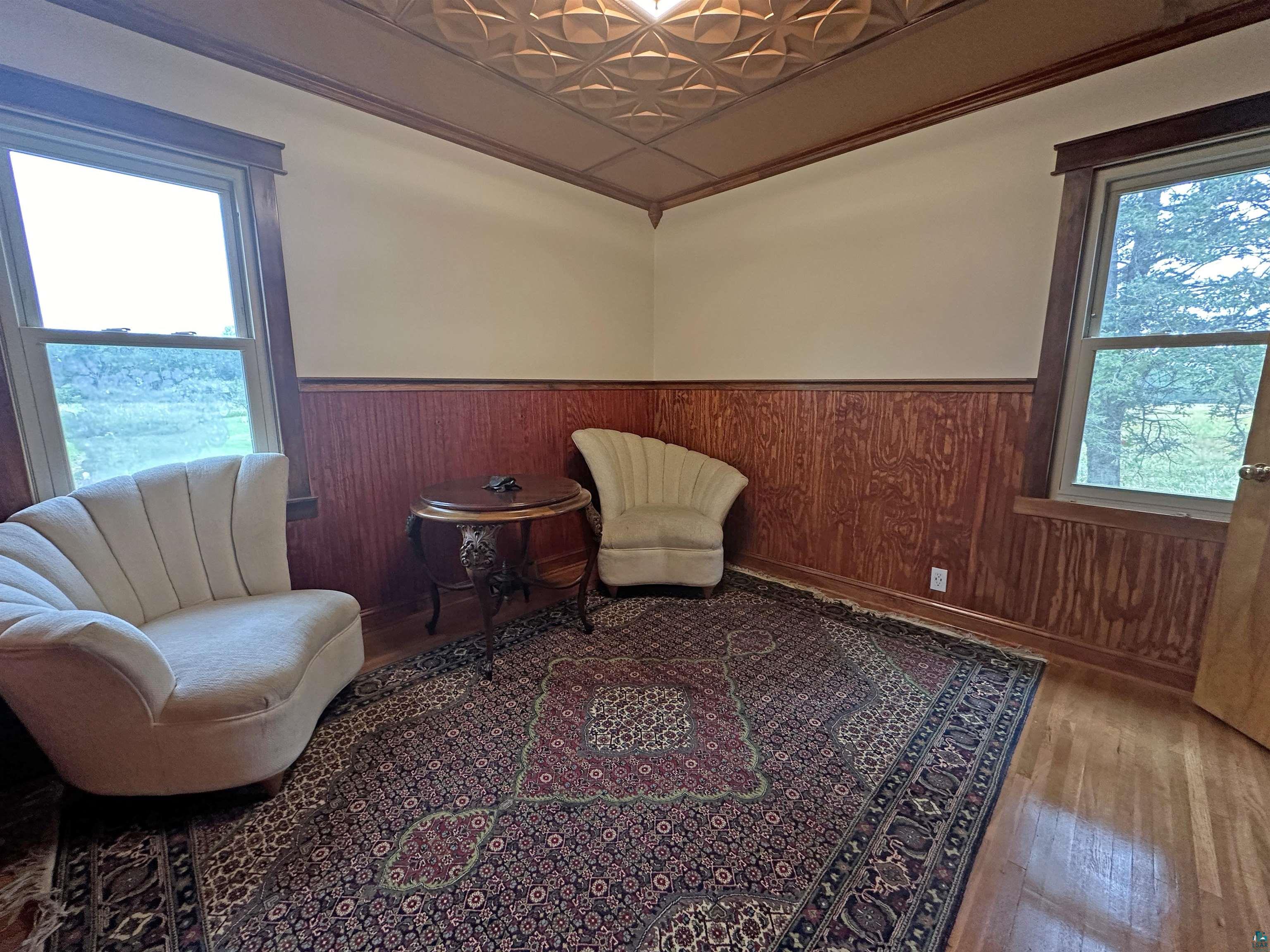 5865 Eastview Road Iron River, WI 54847 - Photo 23 of 41 Sitting room with wood walls, a wealth of natural light, and wood-type flooring
