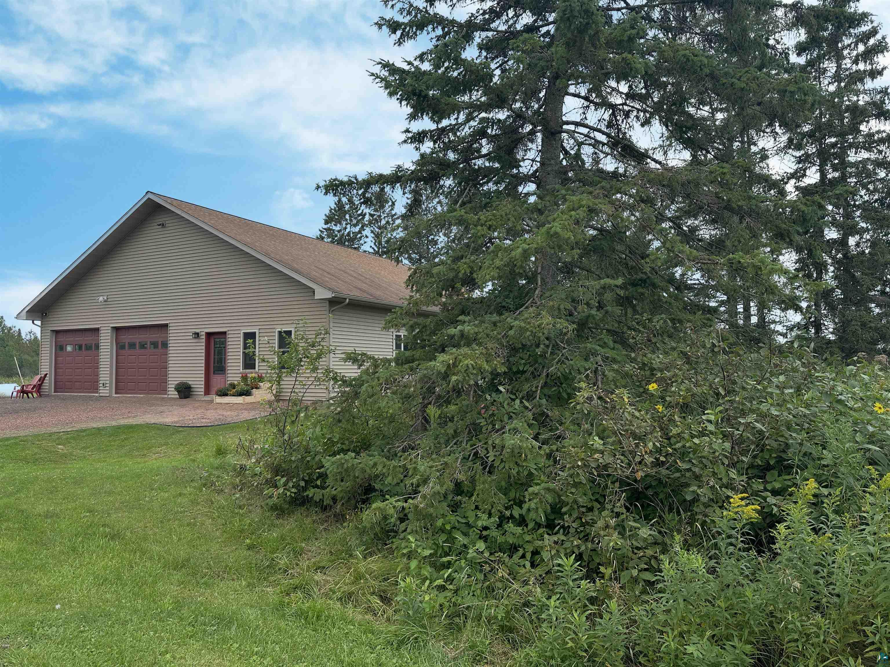 5865 Eastview Road Iron River, WI 54847 - Photo 31 of 41 View of home's exterior with a garage and a yard