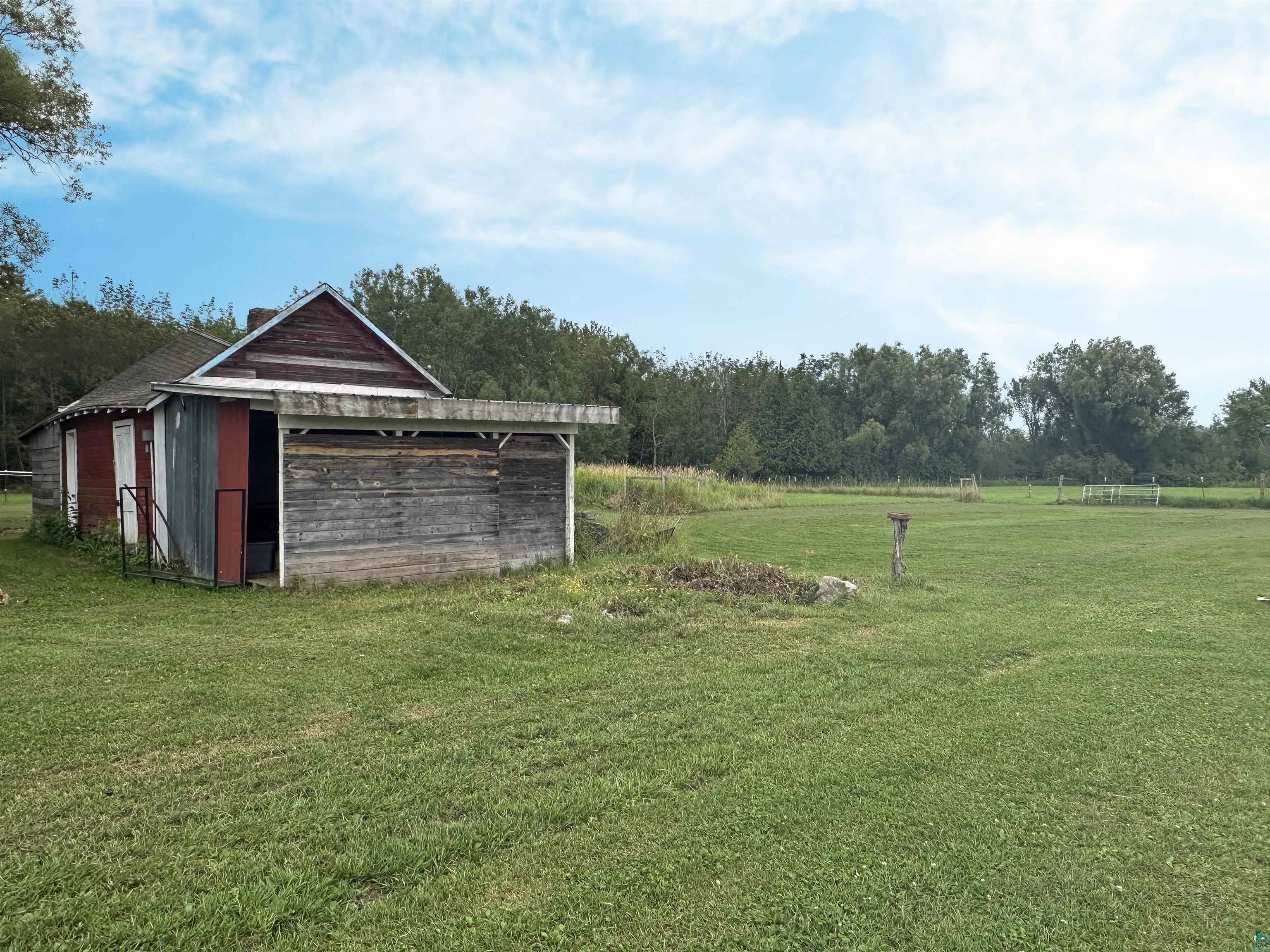 5865 Eastview Road Iron River, WI 54847 - Photo 40 of 41 View of yard featuring a rural view and an outbuilding