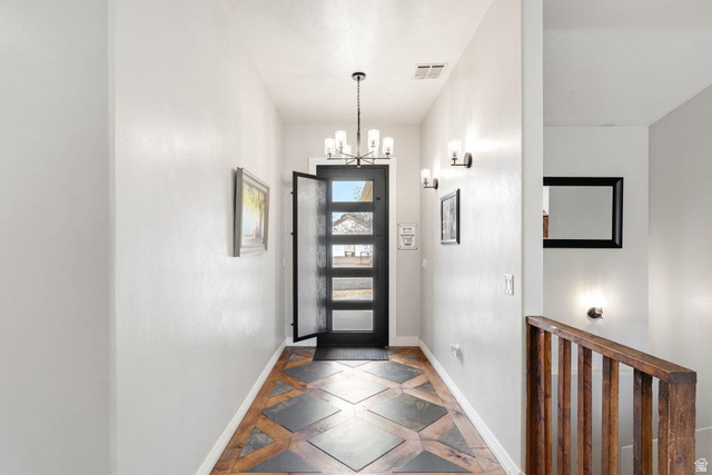 7776 Wagon Road East St. George, UT 84770 - Photo 7 of 76 Entryway featuring inlaid floor details and hanging lights