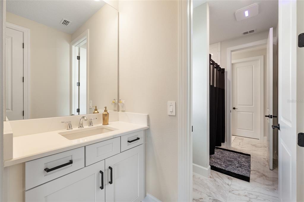 10175 Brocksport Circle Gotha, FL 34734 - Photo 45 of 54 a bathroom with a sink and a mirror