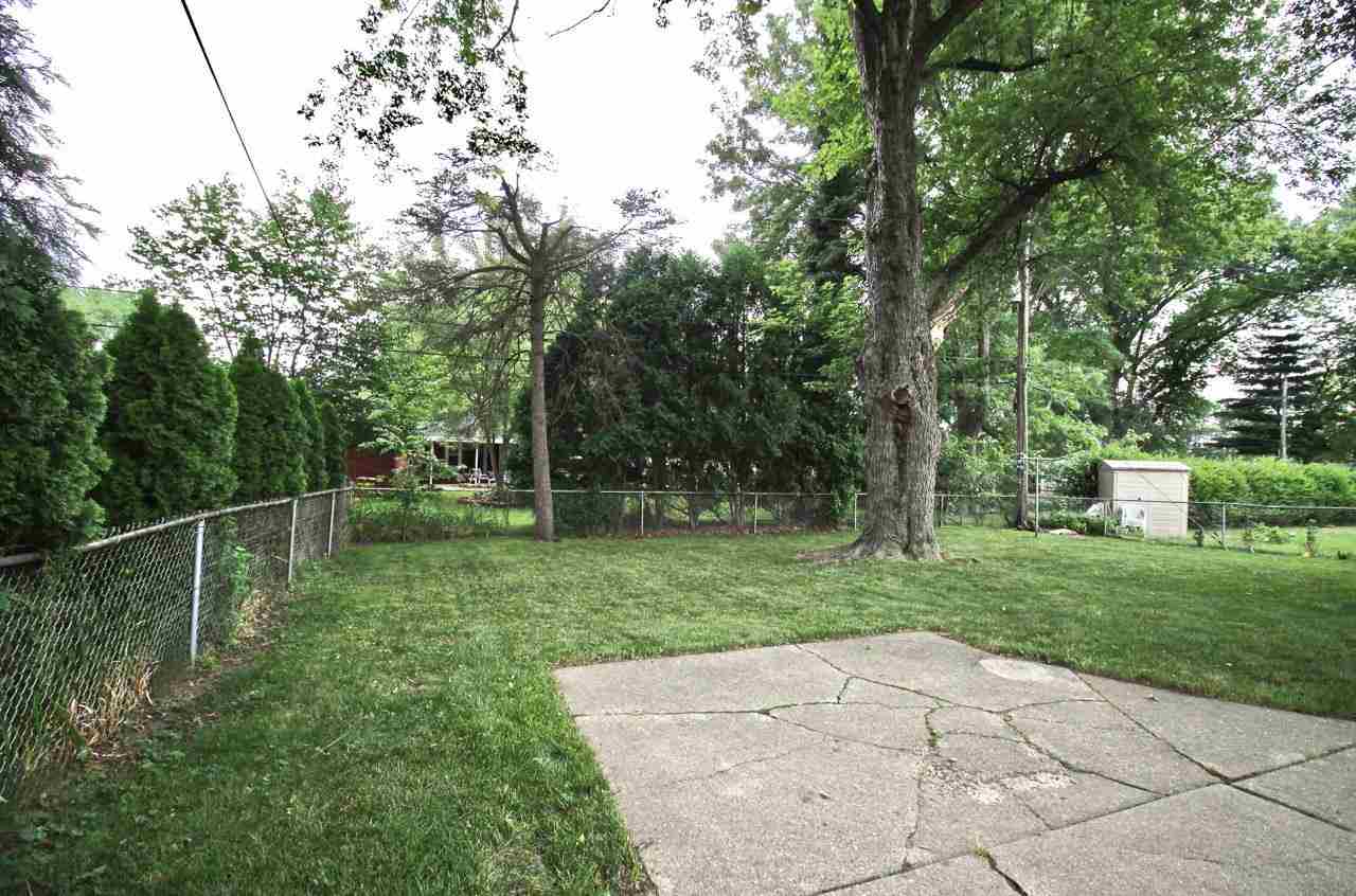 4613 Cayuga Road Rockford, IL 61107 - Photo 17 of 19 a backyard of a house with lots of green space