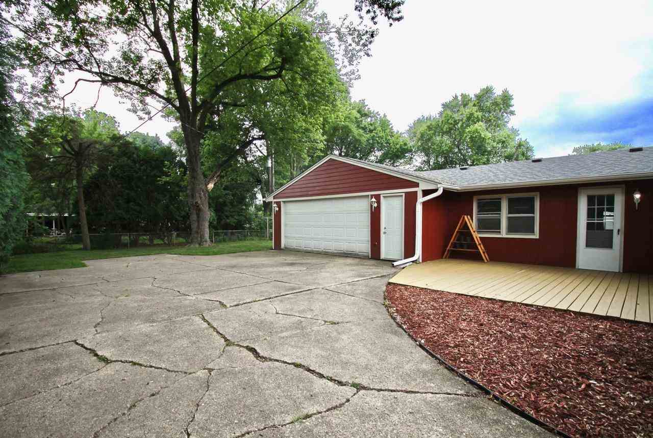 4613 Cayuga Road Rockford, IL 61107 - Photo 19 of 19 a front view of a house with a yard and garage