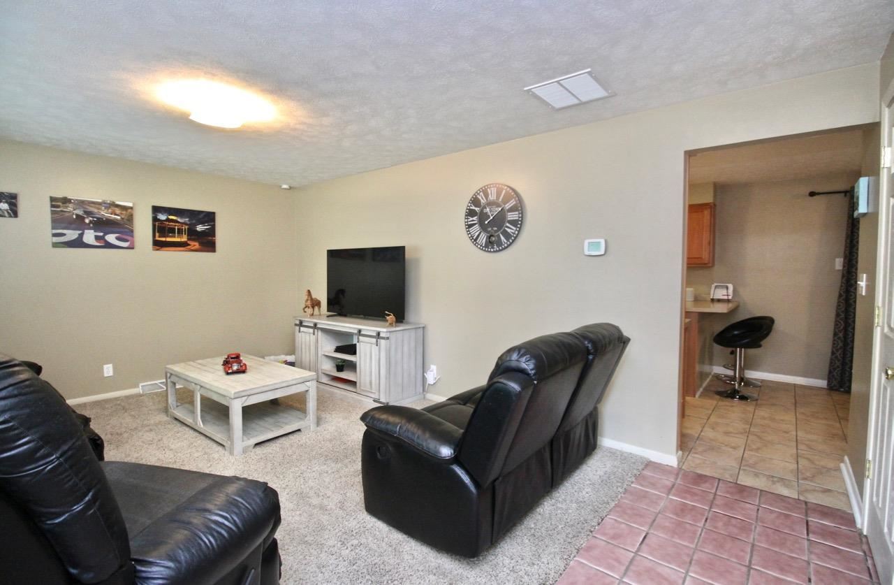 4613 Cayuga Road Rockford, IL 61107 - Photo 3 of 19 a living room with furniture and a flat screen tv