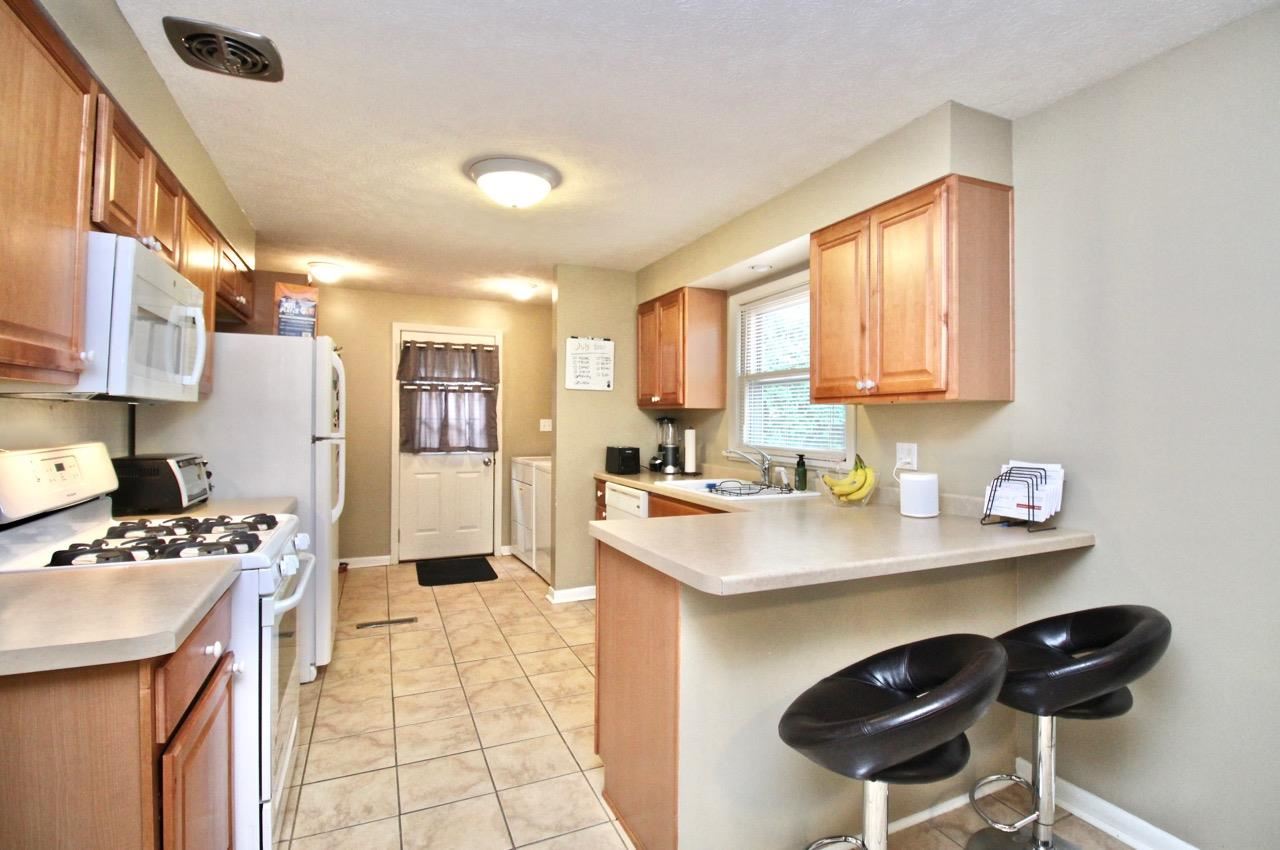 4613 Cayuga Road Rockford, IL 61107 - Photo 5 of 19 a kitchen with stainless steel appliances kitchen island granite countertop a sink and cabinets