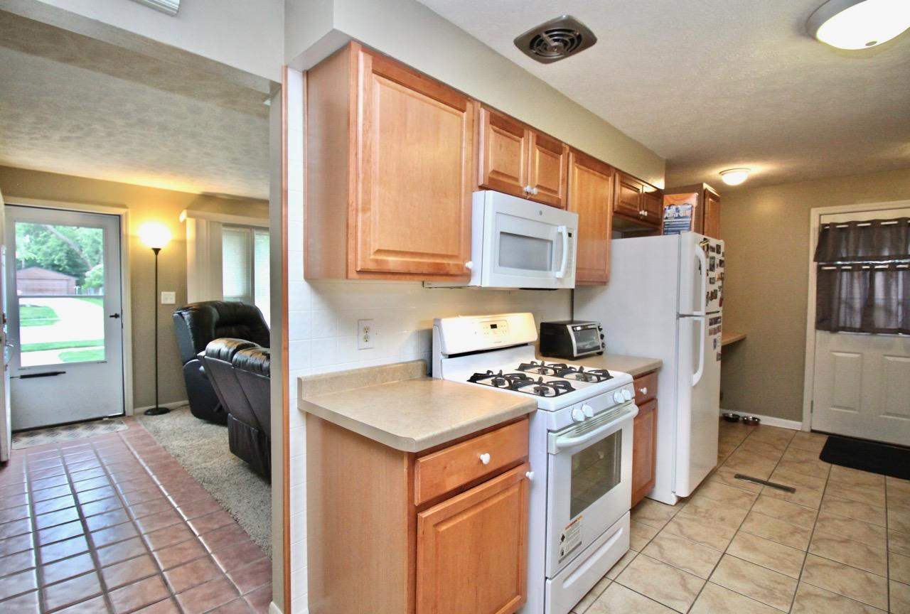 4613 Cayuga Road Rockford, IL 61107 - Photo 7 of 19 a kitchen with a stove cabinets and a refrigerator